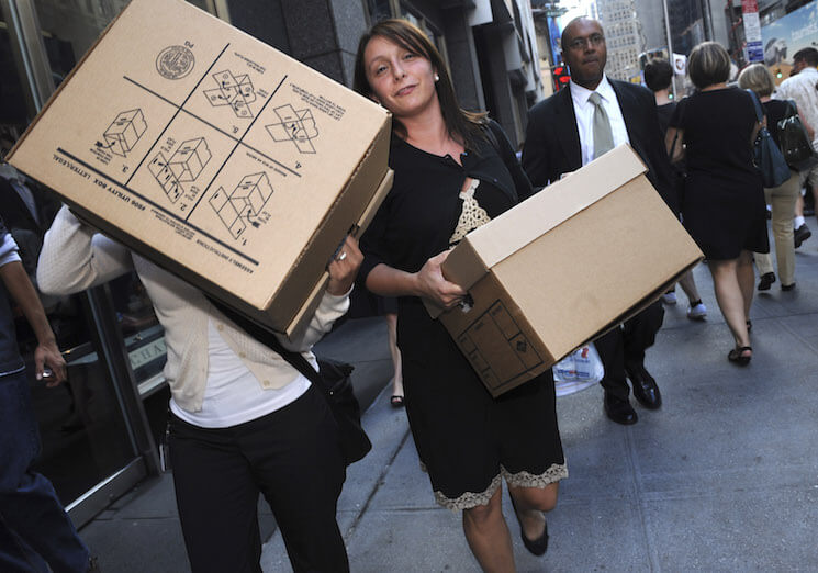 Women carrying boxes leave the Lehman Brothers headquarters, September 15, 2008, in New York on the day the firm filed for bankruptcy. The largest filing in American history, the Lehman Brothers’ bankruptcy unleashed turmoil throughout the global economy. (AP Photo/ Louis Lanzano)