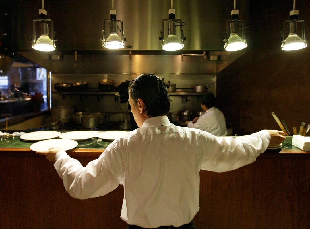 Workers prepare for lunch in a San Francisco restaurant kitchen.