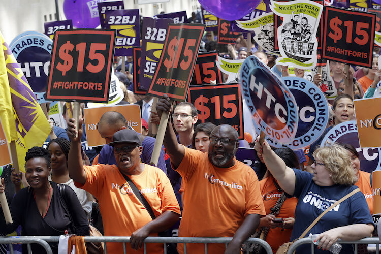 Activists cheer during a minimum wage rally in New York.