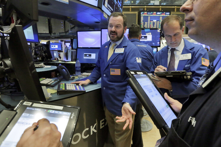 Specialist Charles Boeddinghaus, center, works on the floor of the New York Stock Exchange, Friday, May 13, 2016.