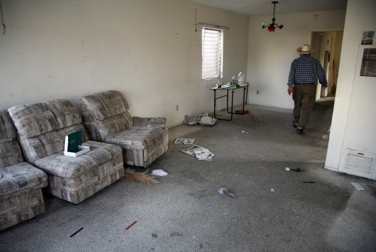 In this March 15, 2009 photo, a man walks through his empty living room as he vacates his home in Culver City, California after losing his property in foreclosure.