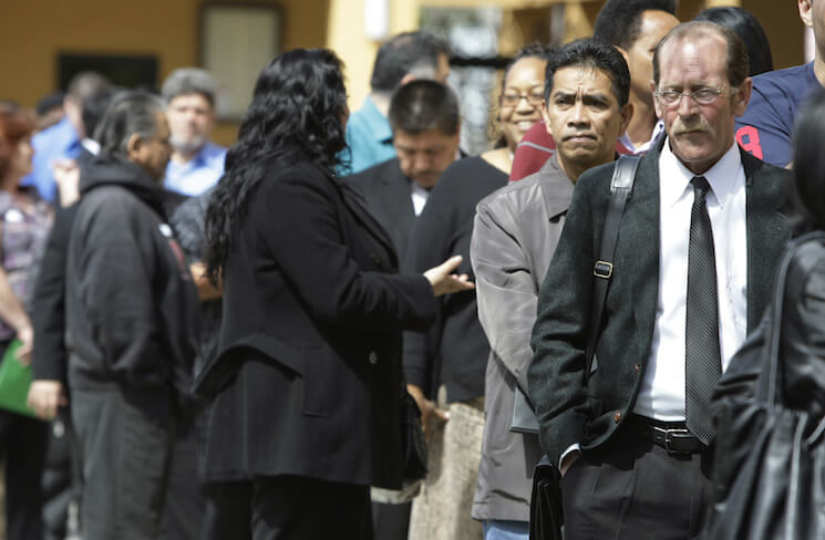 Job applicants wait in a long line at a job fair in San Jose, Calif.