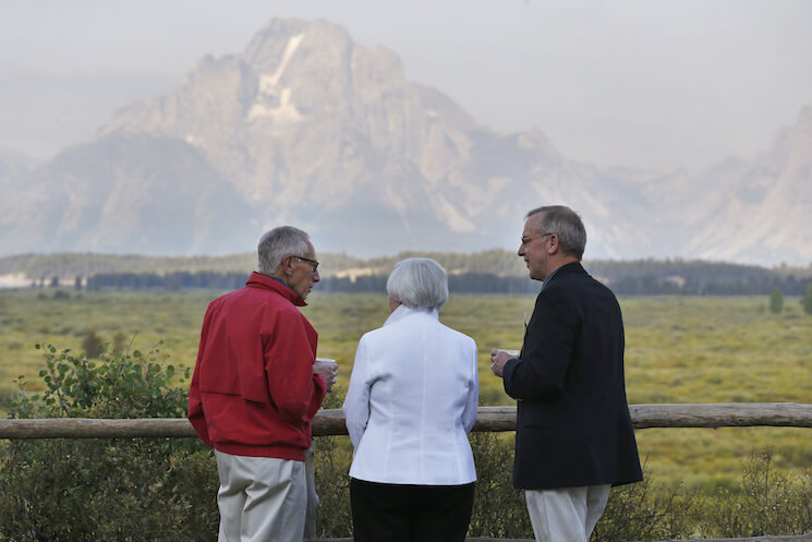 Federal Reserve Chair Janet Yellen, center, Stanley Fischer, left, vice chairman of the Board of Governors of the Federal Reserve System, and Bill Dudley, the president of the Federal Reserve Bank of New York, talk and view the Grand Tetons before Yellen's speech to the annual invitation-only conference of central bankers from around the world, sponsored by the Federal Reserve Bank of Kansas City, at Jackson Lake Lodge in Grand Teton National Park, north of Jackson Hole, Wyo., Friday, Aug 26, 2016.