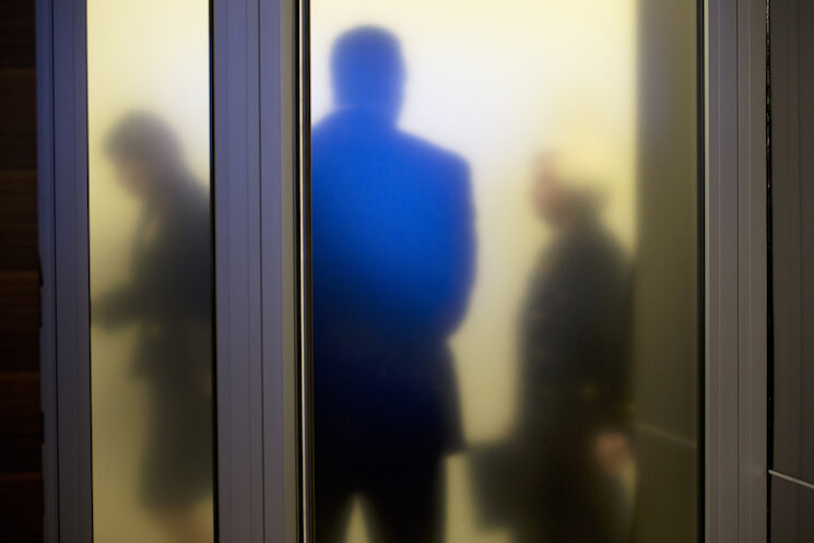 Federal Reserve Chair Janet Yellen, right, walks past a frosted glass door at the Federal Reserve. 