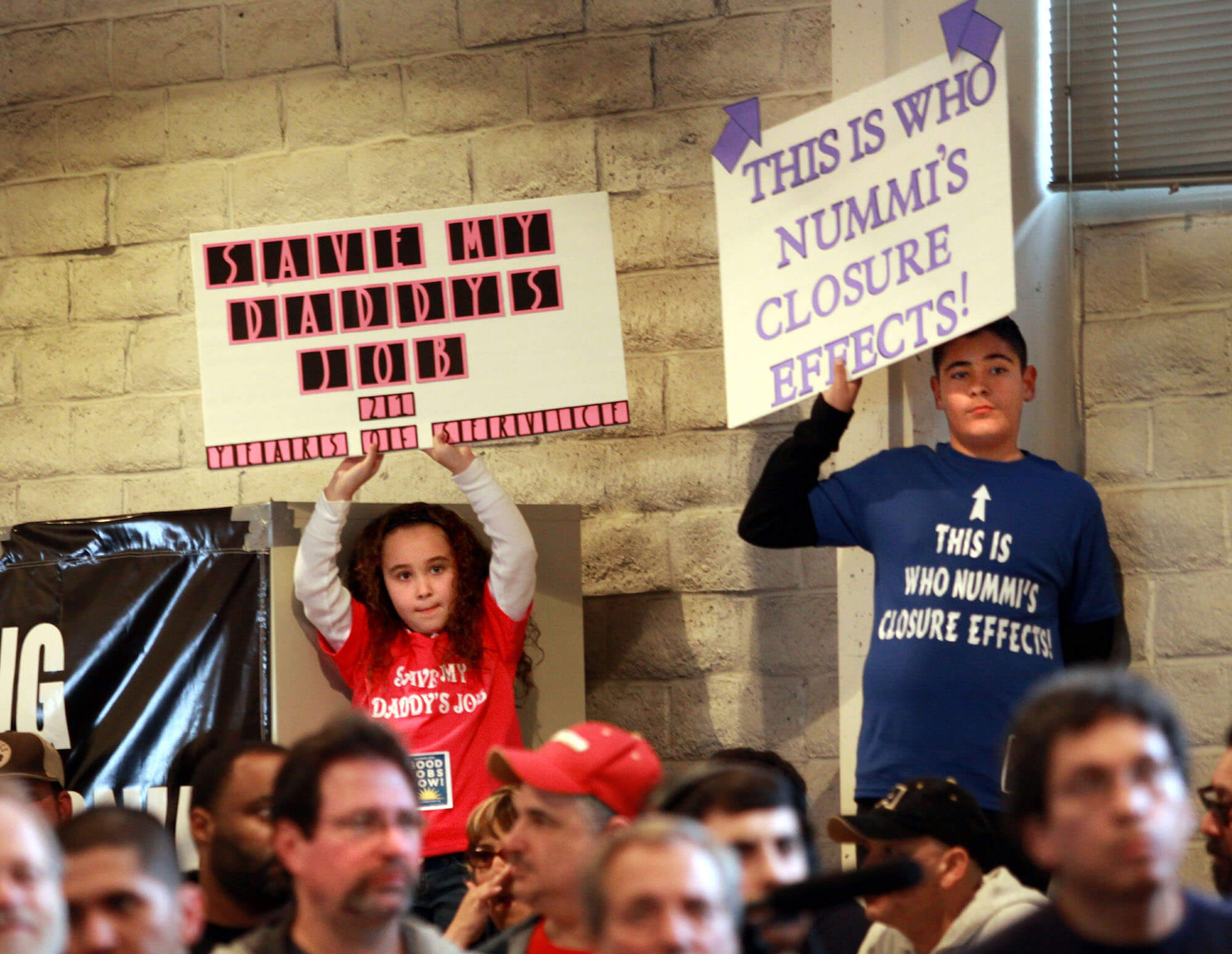Marissa Perez and her brother Austin hold up signs for their father's job during a rally at the United Auto Workers Hall that hoped to persuade Toyota not to close its New United Motor Manufacturing Inc. automobile assembly plant, Friday, Feb. 12, 2010 in Fremont, Calif. (AP Photo/Dino Vournas)