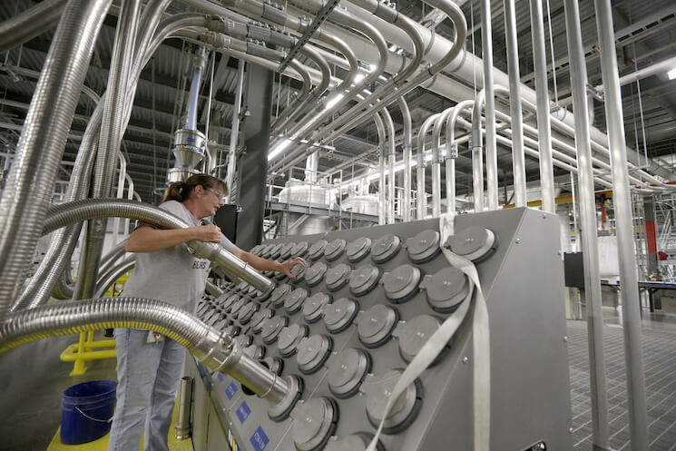 Susan Stacy moves a tube to sort recycled plastic bottle chips being processed at the Repreve Bottle Processing Center, part of the Unifi textile company in Yadkinville, N.C., Friday, Oct. 21, 2016. 