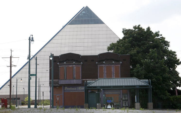 In this June 1, 2016 photo, vacant buildings stand near the Pyramid which houses a Bass Pro Shops megastore that opened in 2015, in Memphis, Tenn. Statistics describe an America that is nearly recovered from the Great Recession, but the national averages don’t give a complete or accurate picture. Wealth is flowing disproportionately to the rich, skewing the data used to measure economic health.