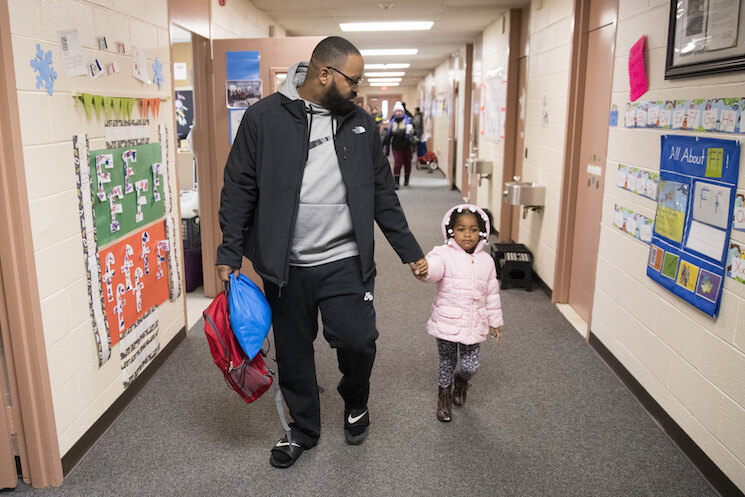 Eric Grant takes his three-year-old daughter Makayla to preschool in Philadelphia, Friday, Jan. 6, 2017. 