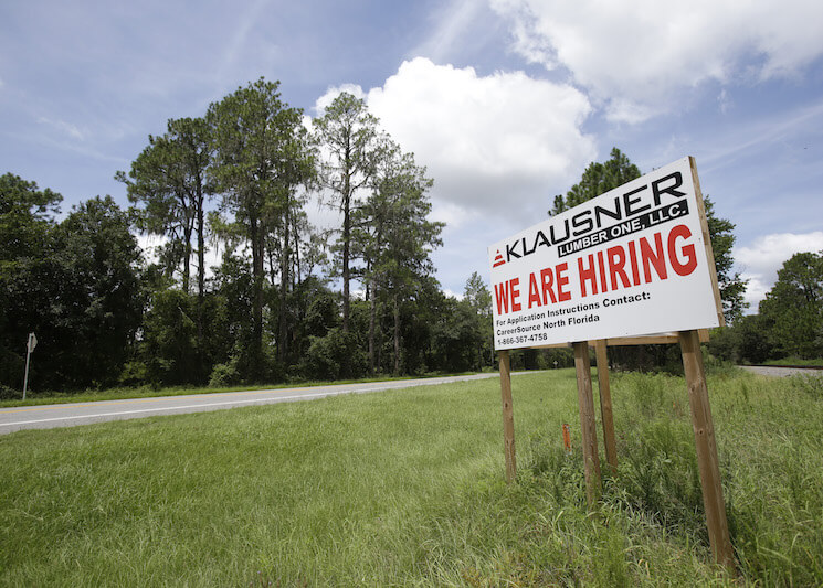 A sign along US 90 advertises job openings at the Klausner lumber mill in Live Oak, Fla. 