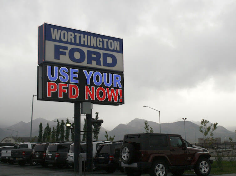 An auto dealership in Anchorage, Alaska, advertises PFD, or Permanent Fund Dividend, sales.