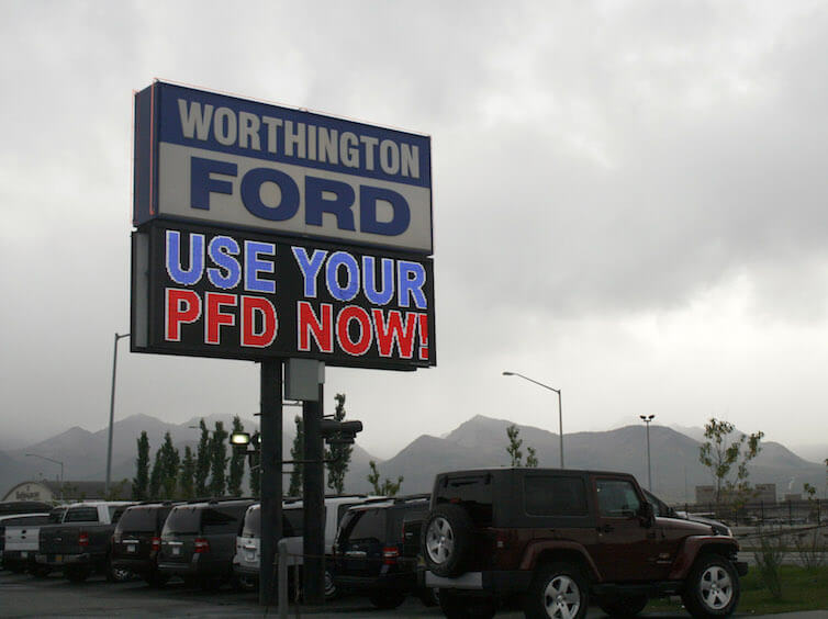 An auto dealership in Anchorage, Alaska, advertises PFD, or Permanent Fund Dividend, sales. 