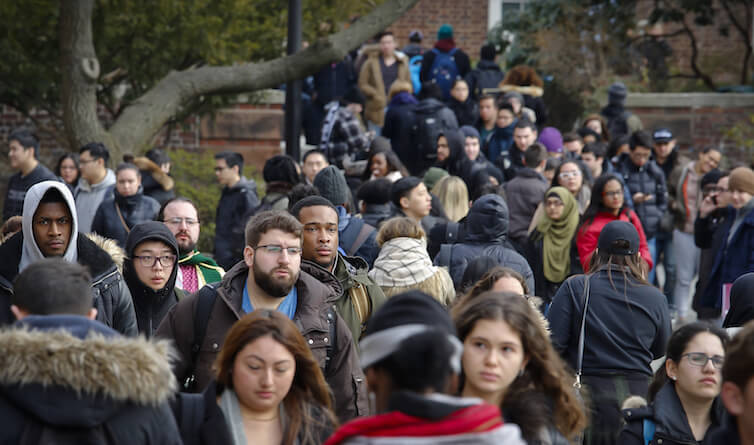 Brooklyn College students walk between classes on campus in New York.  