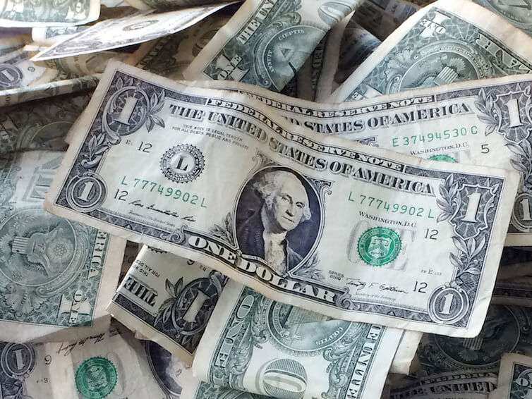 One dollar bills in a tip jar at a car wash in Brooklyn, NY. 