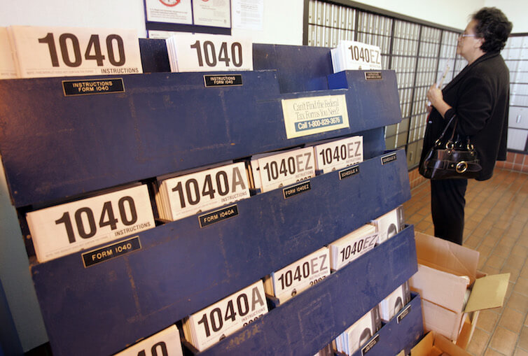 Federal tax forms on display at a U.S. Post Office. 