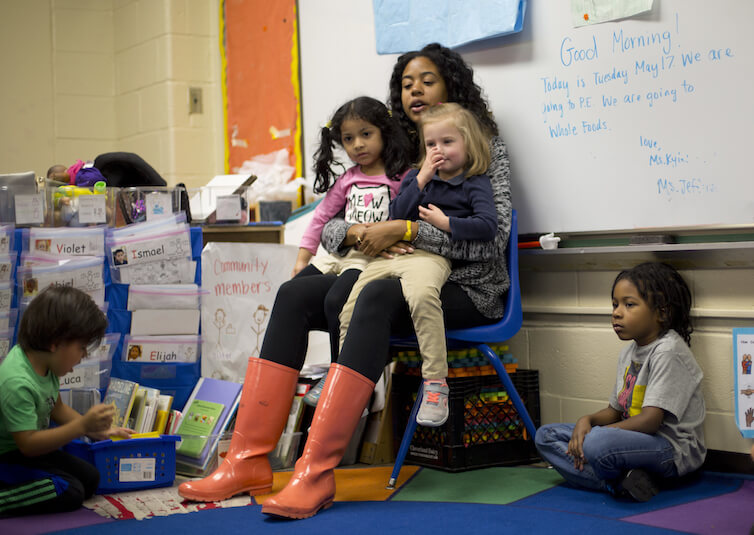Pre-K teacher Epernay Kyles, center, talks about class activities with her students.