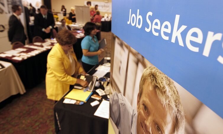 People walk by the recruiters at a jobs fair in the Pittsburgh suburb of Green Tree, Pennsylvania.