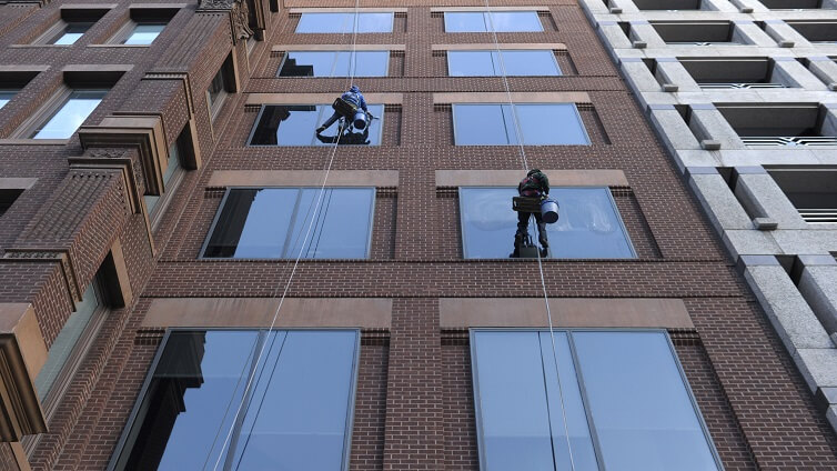Window washers clean windows on a building in Washington.