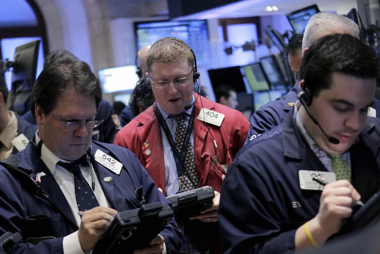 Traders work on the floor at the New York Stock Exchange in New York.