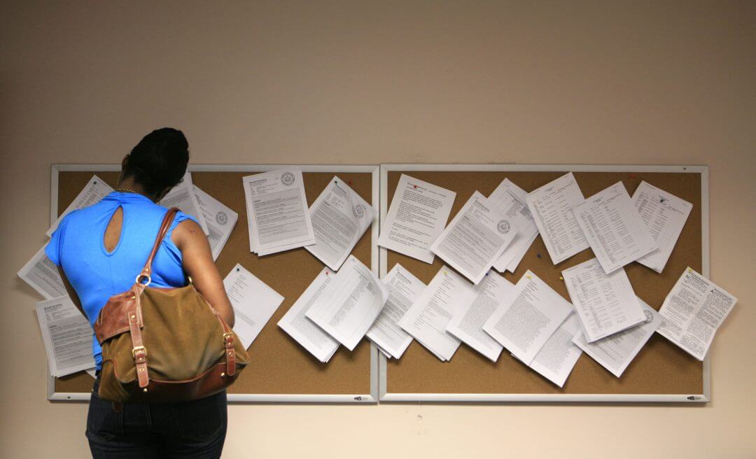 A woman looks at job postings at the New York State Department of Labor, July 2009.