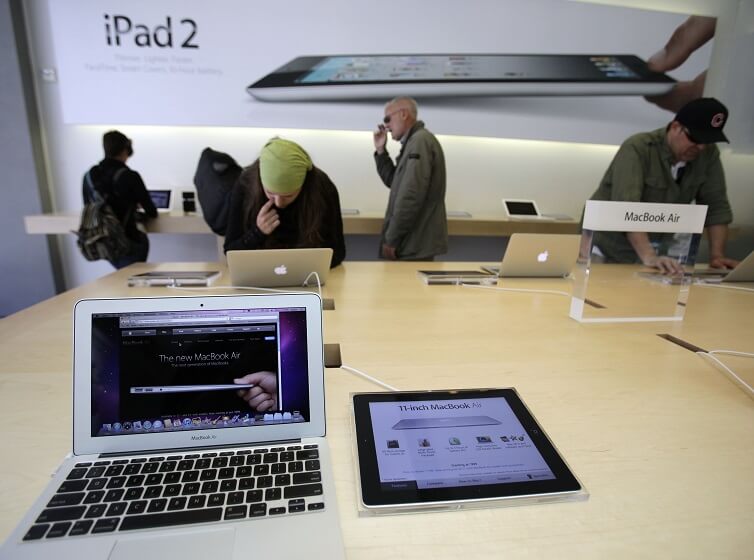 Customers look at the Apple MacBook Air and the iPad 2 at the Apple Store in San Francisco. 