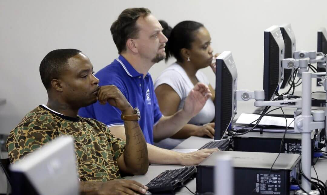 People look at their respective computer screens during a resume writing class in Dallas, March 2017.