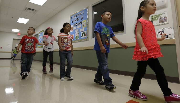 Pre-K students walk in a line at the South Education Center in San Antonio, Texas. 