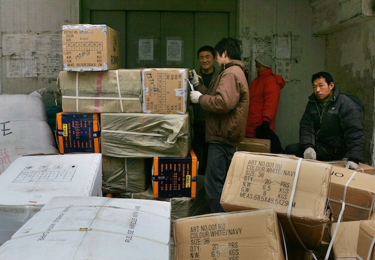 Chinese workers prepare to send off goods meant for export in Beijing. 