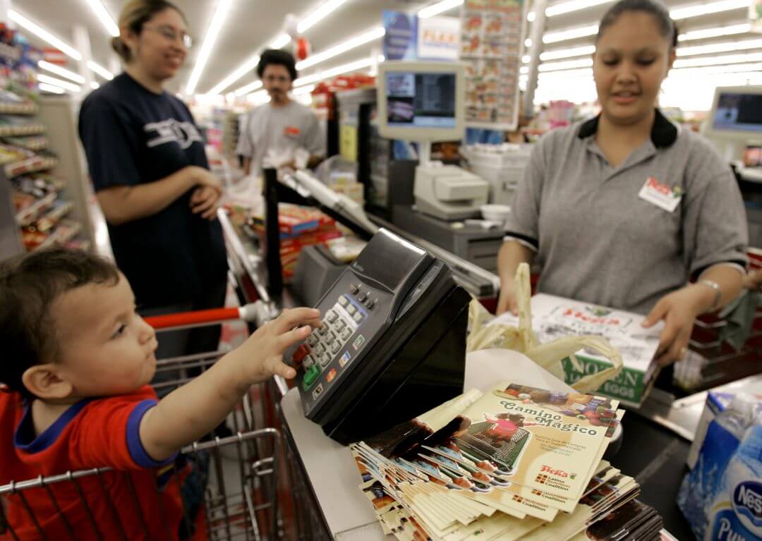 A clerk checks out a customer’s groceries at a grocery store in Houston, May 2007.