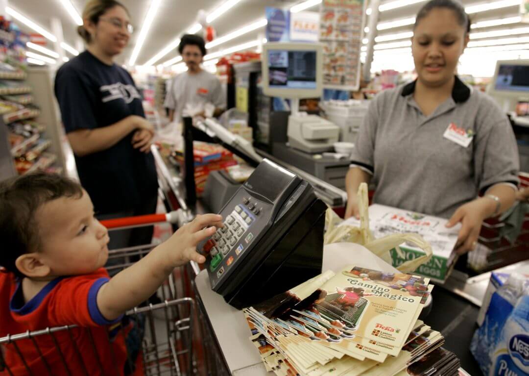 A clerk checks out a customer's groceries at a grocery store in Houston, May 2007.