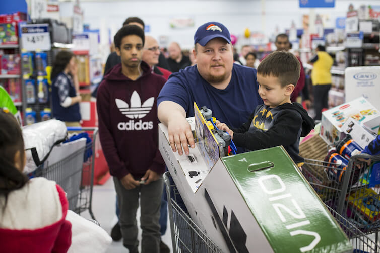 Customers wait in line to make their purchases at Walmart. 