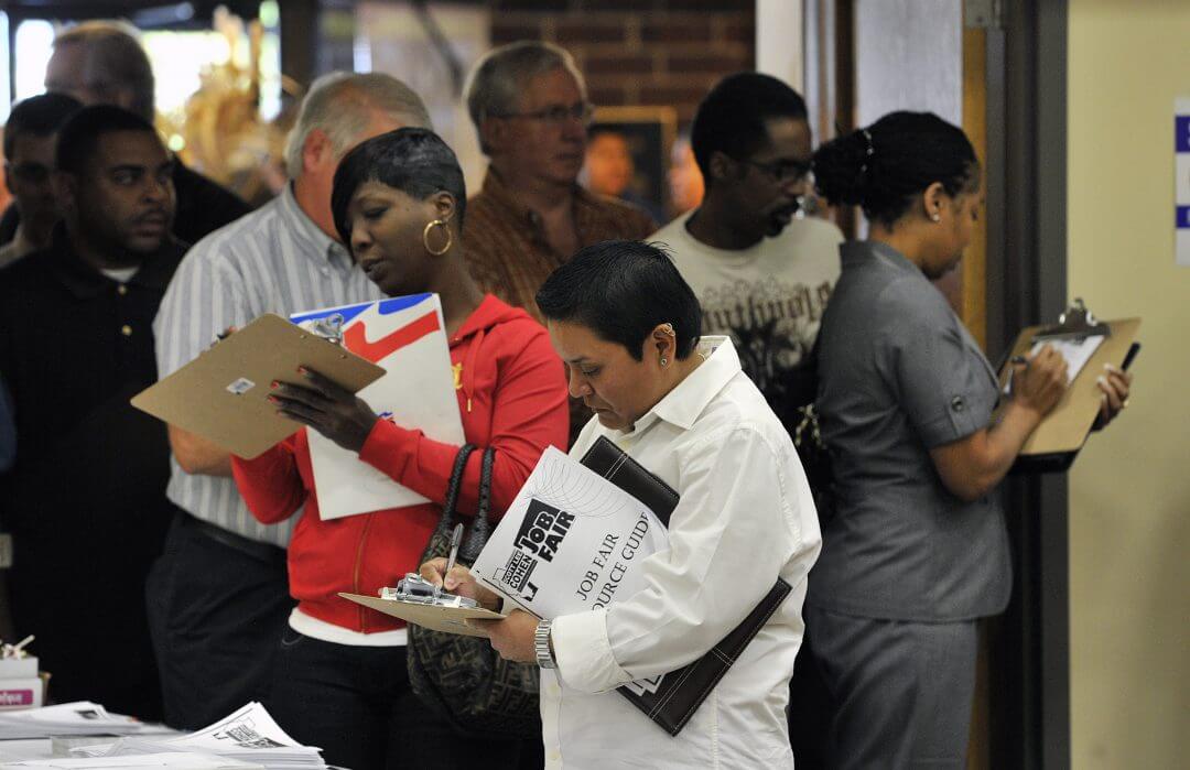 Unemployed workers fill out applications during a jobs fair sponsored by Scott Lee Cohen, independent candidate for governor of Illinois, October 2010, in Rockford, Illinois.