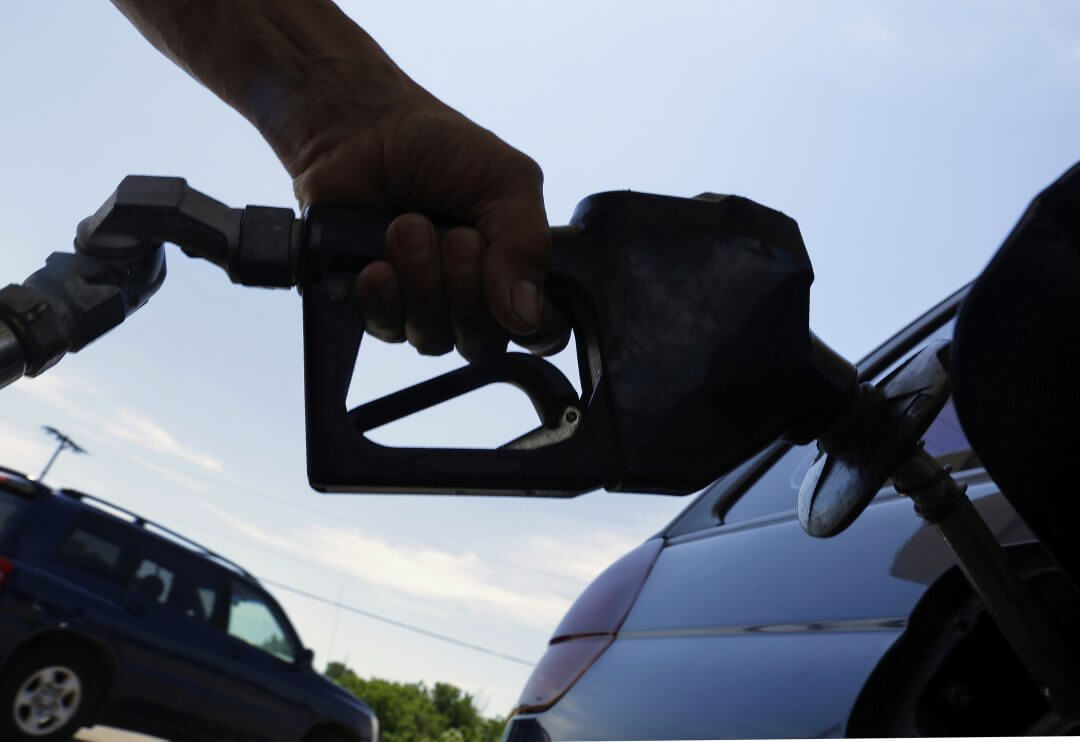 A motorist puts fuel in his car's gas tank at a service station in Springfield, Illinois, June 2013.