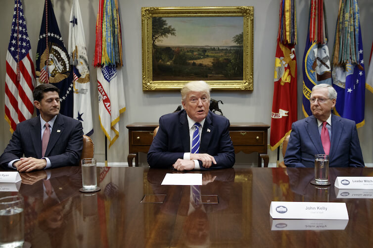 Speaker of the House Rep. Paul Ryan, R-Wis., left, and Senate Majority Leader Mitch McConnell, R-Ky., right, look on as President Donald Trump speaks during a meeting with Congressional leaders and administration officials on tax reform. 