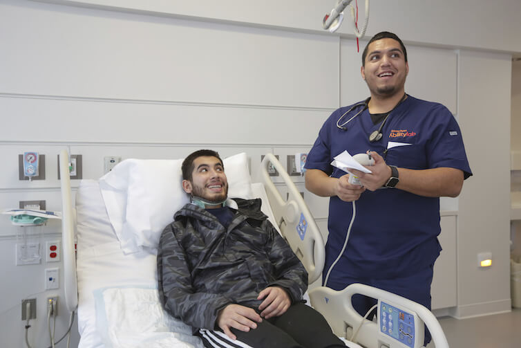 A patient and a registered nurse in a hospital in Chicago. The number of male registered nurses in the United States has increased substantially over the past 40 years.