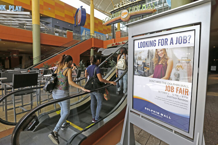 People head to a job fair at Dolphin Mall in Florida.
