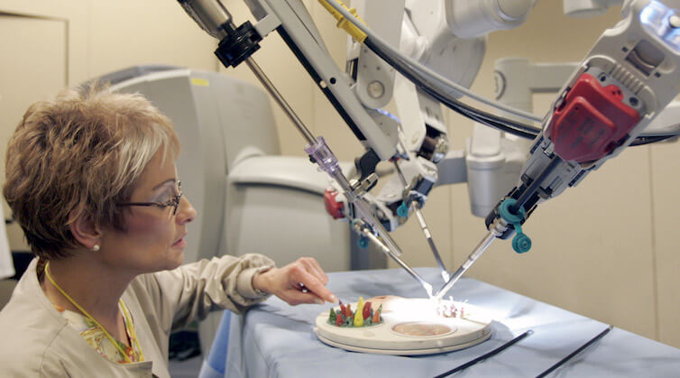 Nurse Charlene Amato-Geib looks at the da Vinci Surgical Robot being demonstrated at Allegheny General Hospital, in Pittsburgh.
