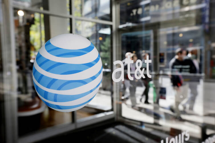An AT&T Inc. logo on a retail store front in Philadelphia. The Department of Justice recently announced it was suing to block AT&T's acquisition of Time Warner Inc.
