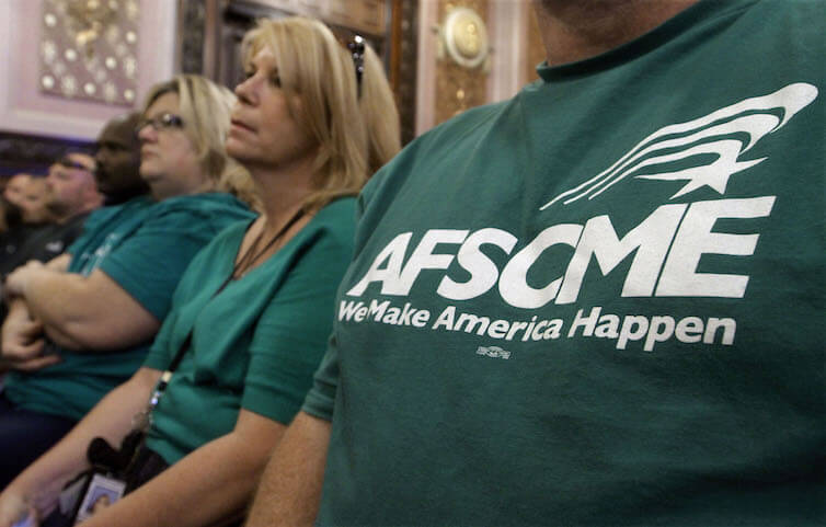 Members of the American Federation of State County and Municipal Employees union attend a forum in Springfield, IL. The recent U.S. Supreme Court decision in <em>Janus v. AFSCME</em> is predicted to decrease the size and budgets of public-sector unions, potentially limiting their effectiveness in collective bargaining for their members.