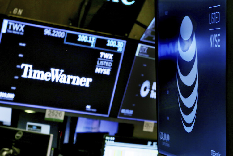 The logos for Time Warner and AT&T appear on the floor of the New York Stock Exchange. Earlier this year, a federal judge approved the $85 billion mega-merger of the two companies, potentially ushering in a wave of media consolidation.