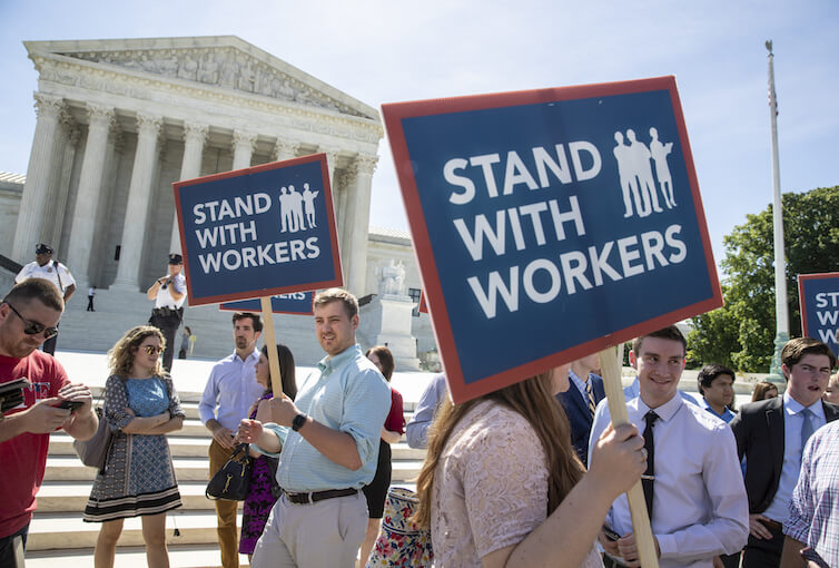 People gather at the Supreme Court awaiting a decision in an Illinois union dues case, <em>Janus vs. AFSCME</em>. Labor Day, this coming Monday, is a good time to reflect on the American labor movement and the impact of unions on workers.