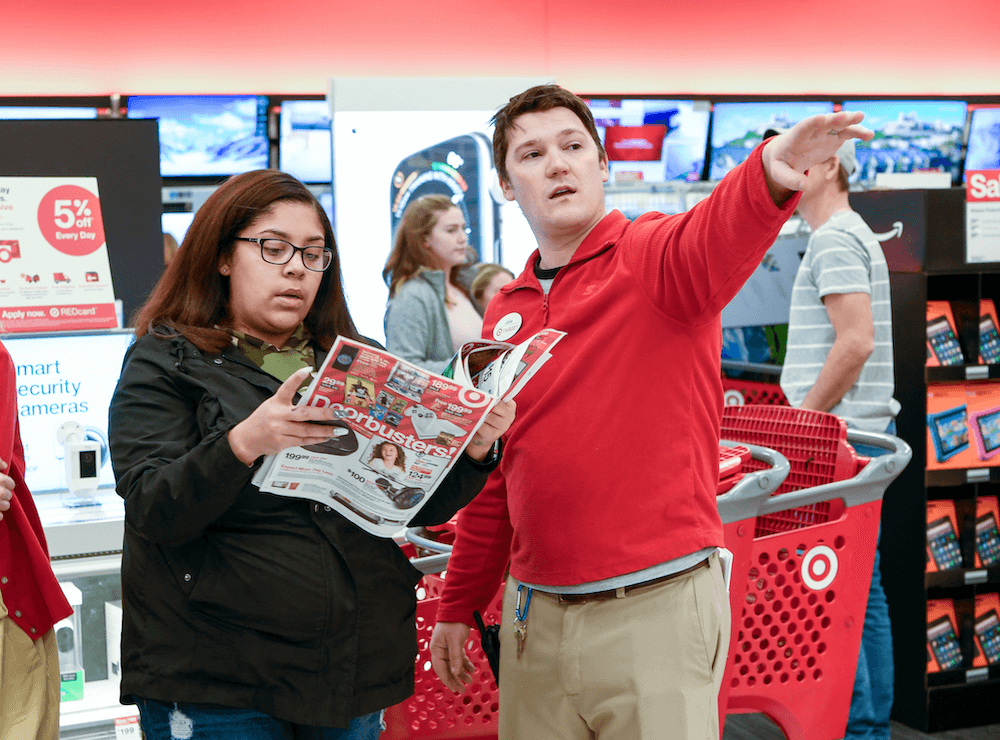 A Target employee helps a Black Friday shopper find top deals at Target on Thursday, Nov. 22, 2018 in Maple Grove, Minnesota.