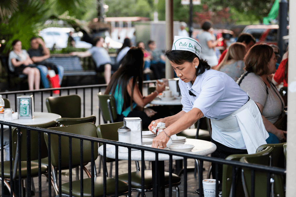 A waitress cleans up after her patrons at New Orleans’ famous Café Du Monde. 