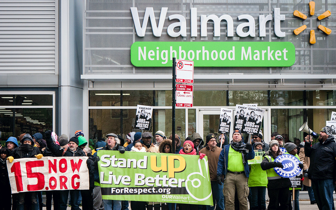 CHICAGO, ILLINOIS - NOVEMBER 28, 2014: Striking Walmart workers and supporters protest against low wages and charge that Walmart retaliates against employees who push for better working conditions.