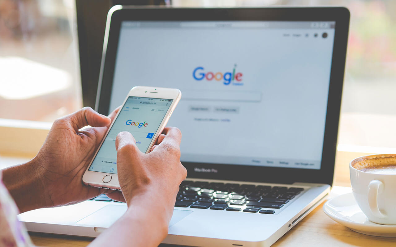 A consumer uses Google on both her phone and her laptop. Google is the most used search engine in the world.