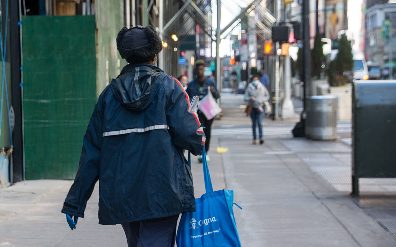 A U.S. postal worker continues on her route in New York City during the coronavirus pandemic, April 6th.