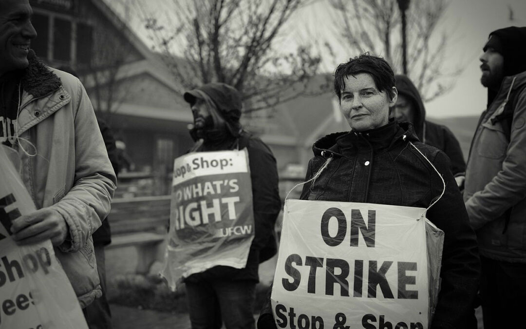 An employee of the Nantucket Stop &amp; Shop stands in the rain shortly after local management forced strikers off the property.